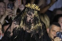 Madonna stands at the end of the Dolce & Gabbana Spring Summer 2025 fashion show, that was presented in Milan, Italy, on Sept. 21, 2024. (AP Photo/Antonio Calanni)