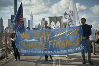 Protesters cross the Brooklyn Bridge during a Youth Climate Strike march to demand an end to the era of fossil fuels, on Sept. 20, 2024, in New York. (AP Photo/Andres Kudacki)