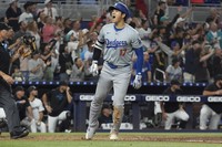 Los Angeles Dodgers' Shohei Ohtani celebrates hitting a two-run home run in the seventh inning in a 20-4 victory against the Miami Marlins, in which he achieved the milestone of 50 home runs and 50 stolen bases for the season, on Sept. 19, 2024. (AP)