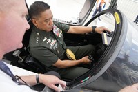 Philippine military chief Gen. Romeo Brawner Jr., right, sits inside the cockpit of a replica of a Saab Gripen combat aircraft during the Asian Defense and Security Exhibition on Sept. 25, 2024, in Manila, Philippines. (AP Photo/Aaron Favila) 