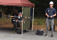 A speaker-equipped drone is seen being controlled by an operator in the town of Fujikawaguchiko, Yamanashi Prefecture, on Sept. 18, 2024. (Mainichi/Kaoru Sato)