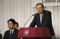 Japan's former Defense Minister Shigeru Ishiba, a candidate in the ruling Liberal Democratic Party (LDP) presidential election, speaks next to fellow candidate former Environment Minister Shinjiro Koizumi during a joint news conference at the party's headquarters in Tokyo on Sept. 13, 2024. (Franck Robichon/Pool Photo via AP) 
