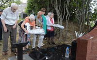 Dutch visitors who were interned by the former Japanese military during World War II offer flowers at the memorial monument in Fukuoka Prisoner of War Camp No. 14, in the city of Nagasaki on Sept. 23, 2024. (Mainichi/Arina Ogata)