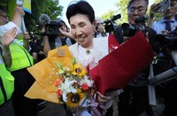 Hideko Hakamada, center, smiles holding bouquets of flowers given by supporters following her younger brother Iwao's acquittal in a retrial ruling, in the city of Shizuoka's Aoi Ward on Sept. 26, 2024. (Mainichi/Yuki Miyatake)