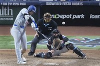 Los Angeles Dodgers' Shohei Ohtani (17) hits a home run scoring Andy Pages during the seventh inning of a baseball game against the Miami Marlins, on Sept. 19, 2024, in Miami. (AP Photo/Wilfredo Lee)