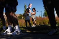 Accompanying their father, who works for Boeing, Kassie Odo, 2, and Iya Odo, 4, hold small picket signs, on Sept. 24, 2024, as Boeing workers strike near the company's factory in Renton, Wash. (AP Photo/Lindsey Wasson)