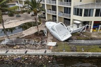 Boats sit after being pushed ashore by floodwaters from Hurricane Helene on Sept. 28, 2024, in St. Petersburg, Fla. (AP Photo/Mike Carlson)