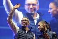 Head of the Freedom Party (FPOE) Herbert Kickl, left, waves to supporters beside party colleague Susanne Fuerst after his speech at a final election campaign event at St. Stephen's square in Vienna, Austria, on Sept. 27, 2024, ahead of the country's national election which will take place on Sept. 29. (AP Photo/Heinz-Peter Bader)