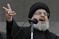 Hezbollah leader Sheik Hassan Nasrallah, speaks to the crowd in a rare public appearance during Ashura, that marks the death of Shiite Islam's Imam Hussein, in the suburbs of Beirut, on Nov. 14, 2013. (AP Photo/Bilal Hussein, File)