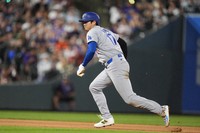 Los Angeles Dodgers' Shohei Ohtani advances from second base to third base on a sacrifice fly hit by Chris Taylor in the sixth inning of a baseball game against the Colorado Rockies on Sept. 28, 2024, in Denver. (AP Photo/David Zalubowski)