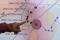Philippine Atmospheric, Geophysical and Astronomical Services Administration weather specialist Veronica Torres points at the path of powerful Typhoon Krathon on Sept. 30, 2024. (AP)