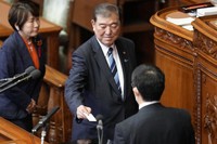 Shigeru Ishiba, center, the head of Japan's ruling party, the Liberal Democratic Party, casts a vote for Japan's new prime minister at the extraordinary session of parliament's lower house on Oct. 1, 2024, in Tokyo. (AP Photo/Eugene Hoshiko)