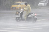 A man struggles in the heavy wind and rain generated by Typhoon Krathon in Kaohsiung, southern Taiwan, on Oct. 3, 2024. (AP Photo/Chiang Ying-ying)