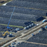 除染で出た土などの仮置き場に積み上がる無数のフレコンバッグ。福島県内各地でこうした光景が見られたが、中間貯蔵施設に搬入されて復興が進んだ＝福島県富岡町で2015年11月27日、本社ヘリから森田剛史撮影