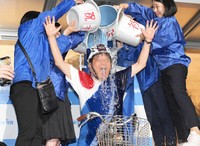 Buckets of cold water are poured over Takashi Kawamura in Nagoya's Higashi Ward on Oct. 27, 2024, in celebration after he was assured of clinching a seat in the House of Representatives election. (Mainichi/Kazuki Yamazaki)