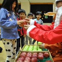 青森県から届いた「善意のリンゴ」を受け取る園児ら＝広島県三原市円一町2で2024年12月2日、関東晋慈撮影