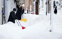 People remove snow on a sidewalk in Niigata, northwest of Tokyo, on Jan. 10, 2025. (Kyodo)