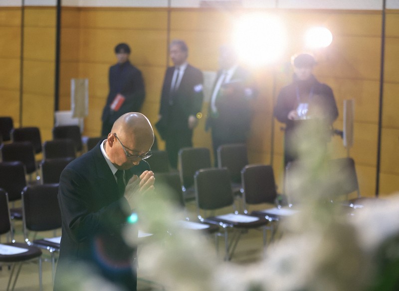 知床観光船沈没事故から3年となり追悼式会場に献花して手を合わせる桜井憲二さん＝北海道斜里町で2025年4月23日午前10時57分、宮間俊樹撮影