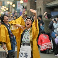 昭和レトロがテーマの「夕日の丘商店街」で東京ブギウギの曲に乗り、歌って踊って観客を盛り上げるキャストたち＝埼玉県所沢市の西武園ゆうえんちで2025年4月26日、手塚耕一郎撮影