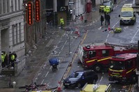 Fans leave as police and emergency personnel deal with an incident after a car collided with pedestrians near the Liver Building during the Premier League winners' parade in Liverpool, England, on May 26, 2025. (AP Photo/Jon Super) 