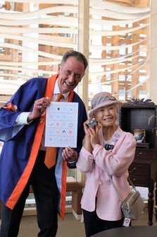 "Expo lady" Tomiyo Yamada, right, receives a stamp from the Dutch pavilion at the World Expo 2025 Osaka, Kansai, after visiting all pavilions at the event, in Osaka's Konohana Ward on May 28, 2025. (Mainichi/Makiko Nagao)