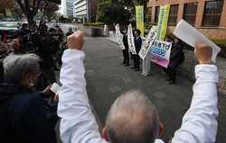 生活保護減額訴訟の名古屋高裁判決を受け「完全勝訴」などと書かれた紙を掲げる原告の弁護士ら＝名古屋市中区で2023年11月30日、兵藤公治撮影