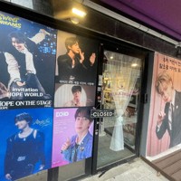 BTSが所属するHYBE本社周辺のカフェに掲げられた、メンバーの除隊を祝うポスター＝ソウル市内のHYBE本社近くで2025年6月10日午前、堀山明子撮影