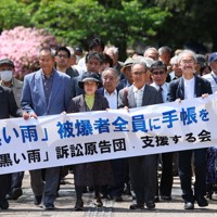 「黒い雨」の新基準に基づき被爆者健康手帳を申請し、却下されたとして広島地裁に集団提訴する原告ら＝広島市中区で2023年4月28日午後1時21分、滝川大貴撮影