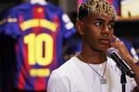 FC Barcelona player Lamine Yamal wears a pendant bearing the number 10 -- his new jersey number -- during a press event following a contract extension with the football club in Barcelona, Spain, on July 16, 2025. (AP Photo/Joan Monfort)