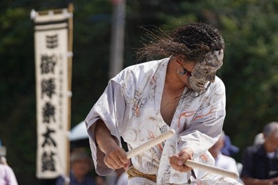 震災の爪痕が残る名舟地区で行われた名舟大祭。披露された御陣乗太鼓の打ち手たちは迫力がある面を付け太鼓を打つ＝石川県輪島市で2025年8月1日午後2時27分、岩本一希撮影