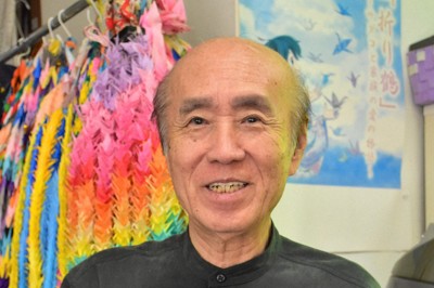 スー・ディシコさんと共同出版した、佐々木禎子さんを伝える英語の児童書を手に、平和記念式典参列への思いを語る兄雅弘さん＝福岡県那珂川市で2025年7月24日、竹林静撮影