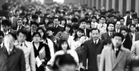 A street near Tokyo's Shinjuku Station is seen crowded with office workers during the morning commute, in April 1991. (Mainichi)