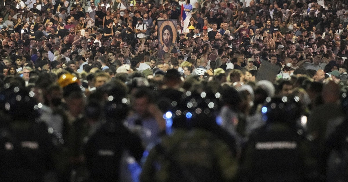 Tensions soar in Serbia as angry protesters clash with police, set fire to party offices
