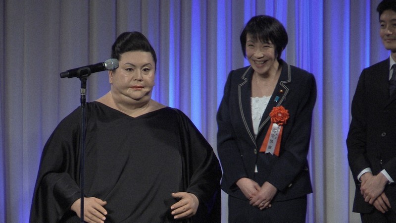 デジタル・コンテンツ・オブ・ジ・イヤー'15の先端科学技術賞に選ばれたマツコロイド（左）と贈賞者として登壇した高市早苗総務相＝東京都港区元赤坂2の明治記念館で2016年3月14日午後5時39分、高原克行撮影