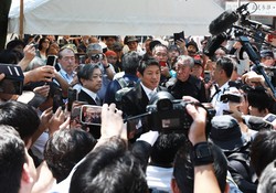 靖国神社参拝を終え、記者の質問に答える参政党の神谷宗幣代表（中央）＝東京都千代田区で2025年8月15日、小出洋平撮影