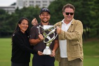 Xander Schauffele, of the U.S., poses for a photo with his parents, Chen Ping-Yi, left, and Stefan Schauffele, after he won the Baycurrent Classic golf tournament at the Yokohama Country Club in Yokohama, near Tokyo, Sunday, Oct. 12, 2025. (AP Photo/Hiro Komae)