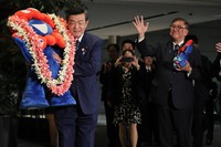 The talking "Myaku-Myaku" figure is carried out of the prime minister's office by Minister for the World Expo 2025 Yoshitaka Ito, as Prime Minister Shigeru Ishiba, right, and others bid farewell following the closing of Expo 2025 Osaka, Kansai, in Tokyo's Chiyoda Ward on Oct. 14, 2025. (Mainichi/Daisuke Wada)