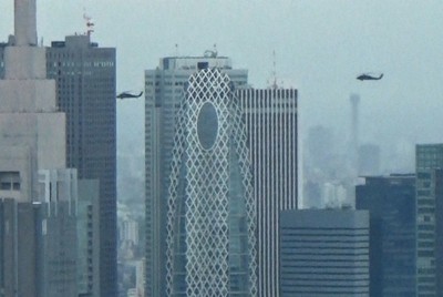 東京・新宿の高層ビル群近くを低空で通過する米陸軍ヘリ「ブラックホーク」2機＝都内で2020年7月9日午後1時10分ごろ、大場弘行撮影（写真は動画から）