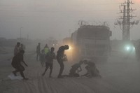 Palestinians rush toward trucks carrying aid from the World Food Programme (WFP) as they drive through Deir al-Balah in central Gaza, on Nov. 8, 2025. (AP Photo/Abdel Kareem Hana)