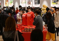 Customers eye store-exclusive products on the first day of business at the new Nintendo Fukuoka store in Fukuoka's Hakata Ward on Nov. 14, 2025. (Mainichi/Tomohisa Yazu)