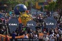 Climate activists protest with coffins that read coal, oil and gas during the COP30 U.N. Climate Summit, Saturday, Nov. 15, 2025, in Belem, Brazil. (AP Photo/Andre Penner)