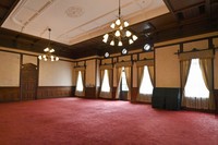 The main hall finished with a coved, coffered and finely latticed ceiling is seen at the former main building of the Kyoto Prefectural Government in the city of Kyoto's Kamigyo Ward, Aug. 7, 2023. There is a balcony outside the windows. (Mainichi/Ai Kawahira)