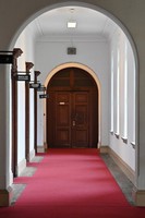 A second-floor hallway with a red carpet is seen at the former main building of the Kyoto Prefectural Government in the city of Kyoto's Kamigyo Ward, Aug. 9, 2023. (Mainichi/Ai Kawahira)
