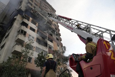 Firefighters work at the scene of an explosion at a residence compound in northern Tehran, Iran, June 13, 2025. (AP Photo/Vahid Salemi)