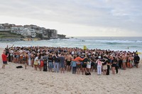 Swimmers gather for a morning vigil in Sydney, Dec. 17, 2025, following Sunday's shooting at Bondi Beach. (Mick Tsikas/AAP Image via AP)/AAP Image via AP)