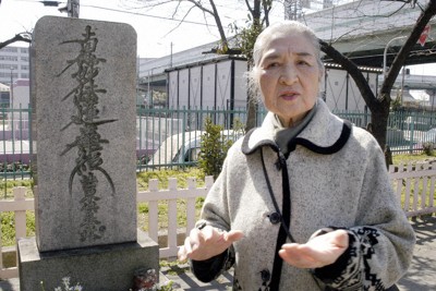 　昭和20年3月13日の大空襲で亡くなった人たちの供養塔前で当時の模様を話す伊賀孝子さん＝大阪市浪速区の浪速西公園で2005年3月7日、国平雅宏写す