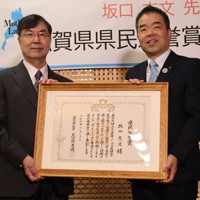 三日月大造知事（右）から県民栄誉賞の賞状を渡された坂口志文さん＝大津市京町4で、菊池真由撮影