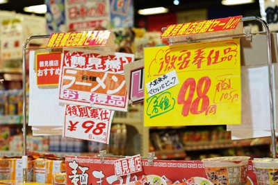 スーパーマーケットの一角に掲げられた値札。「激安奉仕品」の文字が消費者を引きつける＝大阪市西成区で2024年7月11日、村田貴司撮影
