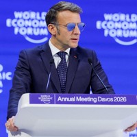 世界経済フォーラム年次総会（ダボス会議）で演説するマクロン仏大統領。目の疾患のためサングラスを着用している＝スイス東部ダボスで2026年1月20日、ロイター