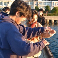 能登高2年の境谷健太郎さん（左）らが企画した「ノトイクツアー」では県内外の高校、大学生が朝日が昇る富山湾で釣りを楽しんだ＝石川県能登町宇出津で、2025年11月23日午前7時3分、中尾卓英撮影